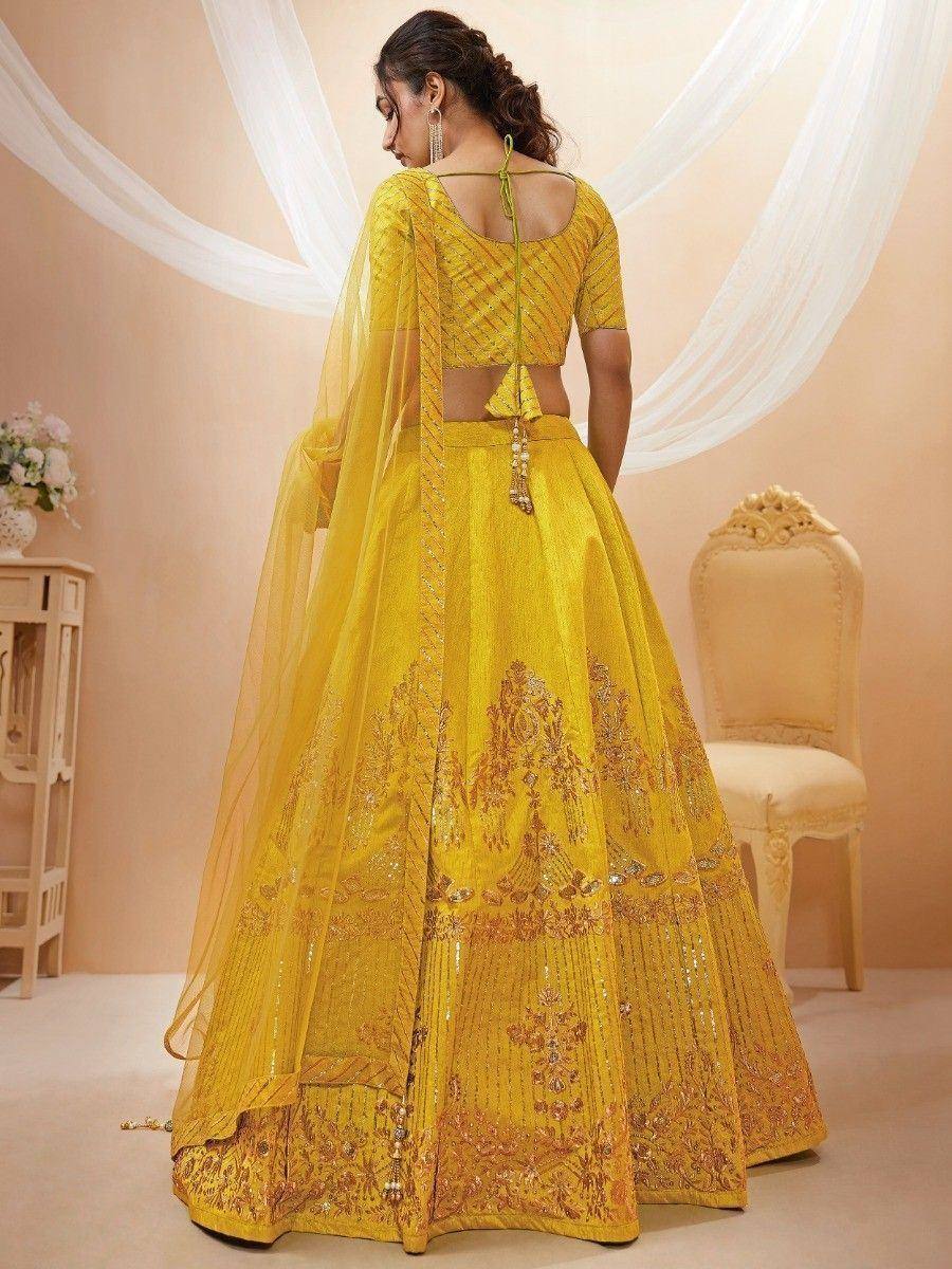 Yellow designer lehenga choli with gold embroidery and sheer dupatta, ethnic wear for women