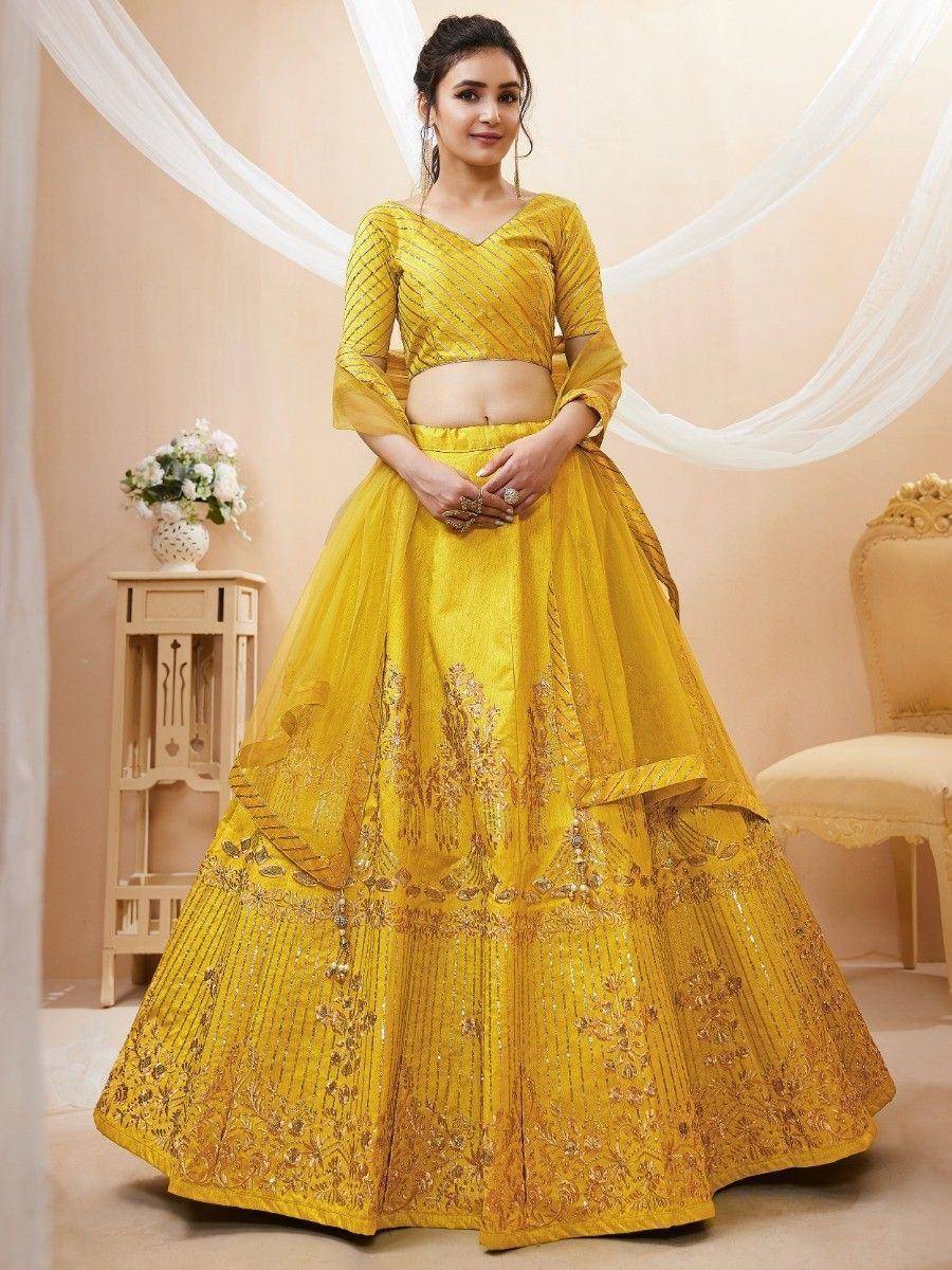 Yellow designer lehenga choli with intricate embroidery and net skirt for Indian ethnic wear