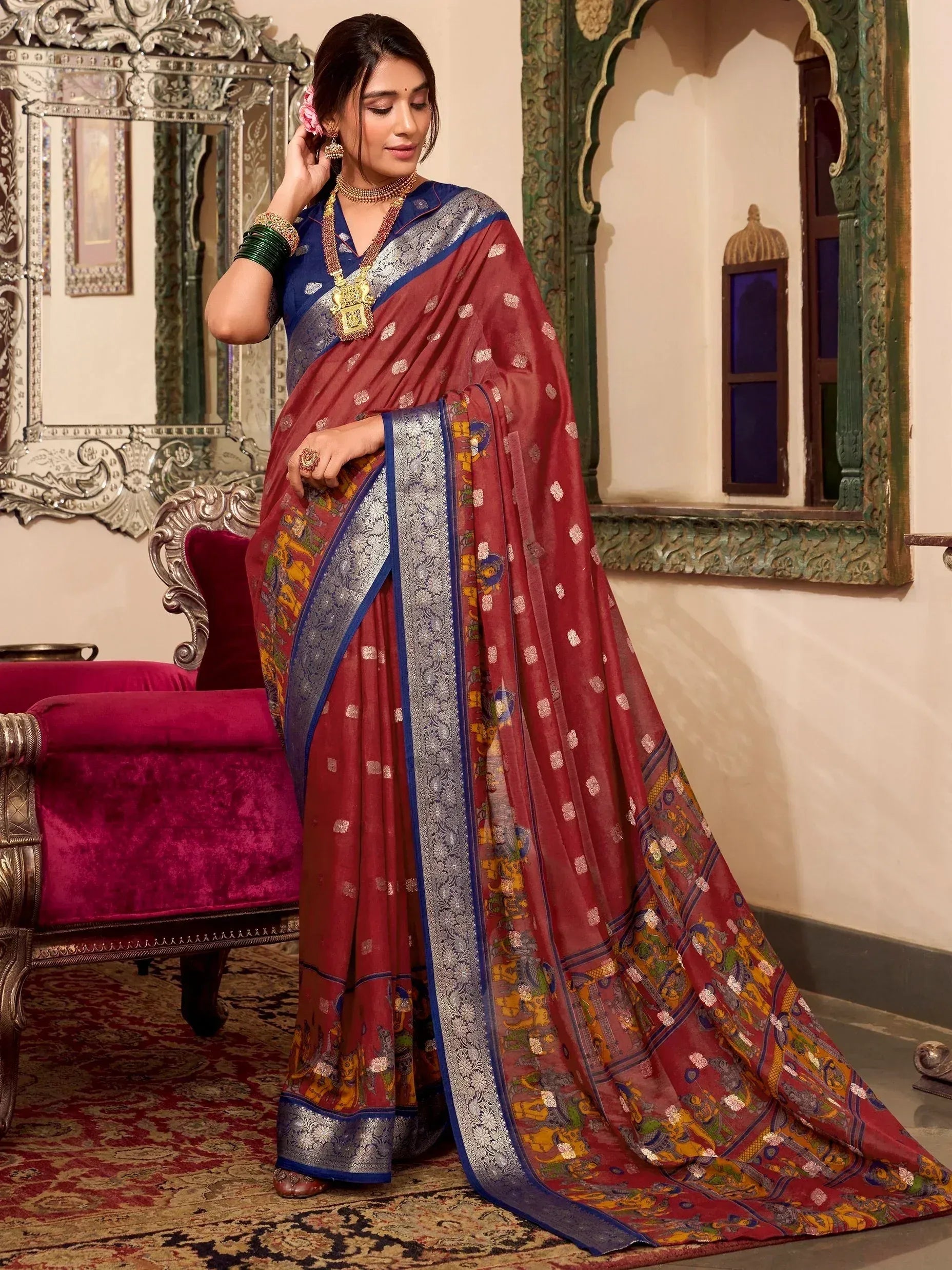 Woman in maroon and blue printed saree with silver border, traditional Indian ethnic wear
