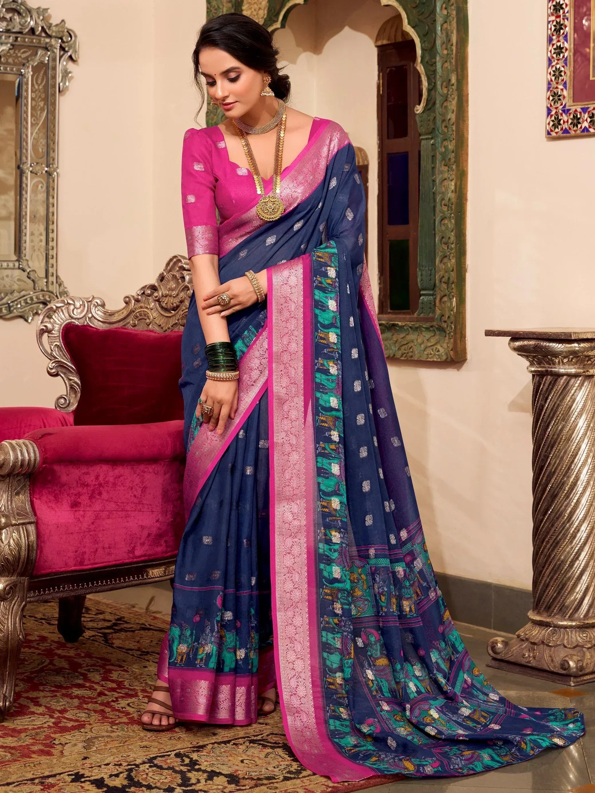 Woman in navy blue and pink printed saree with elephant motifs, traditional Indian ethnic wear