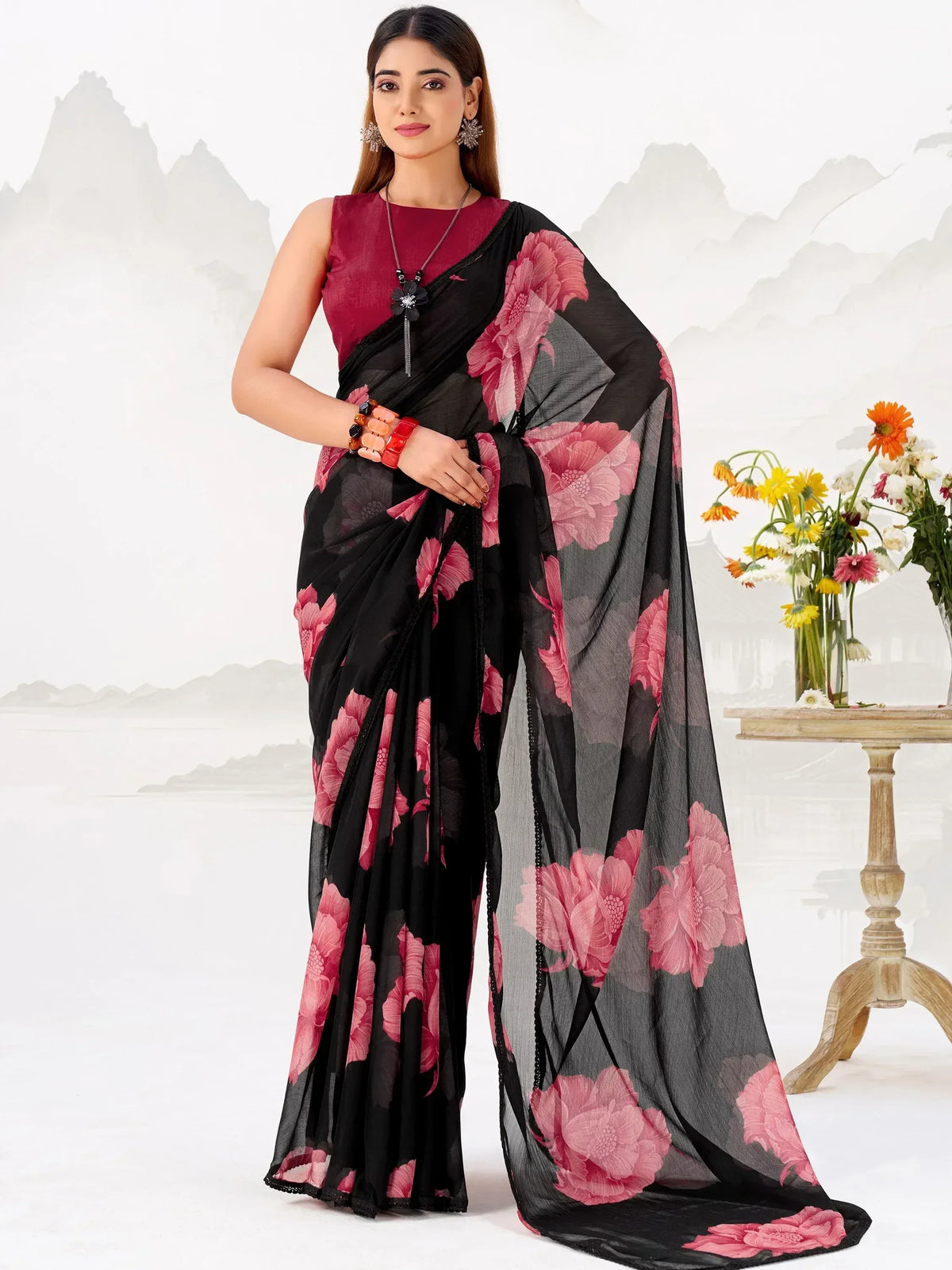 Black saree with pink floral print, paired with maroon blouse, ideal for ethnic occasions