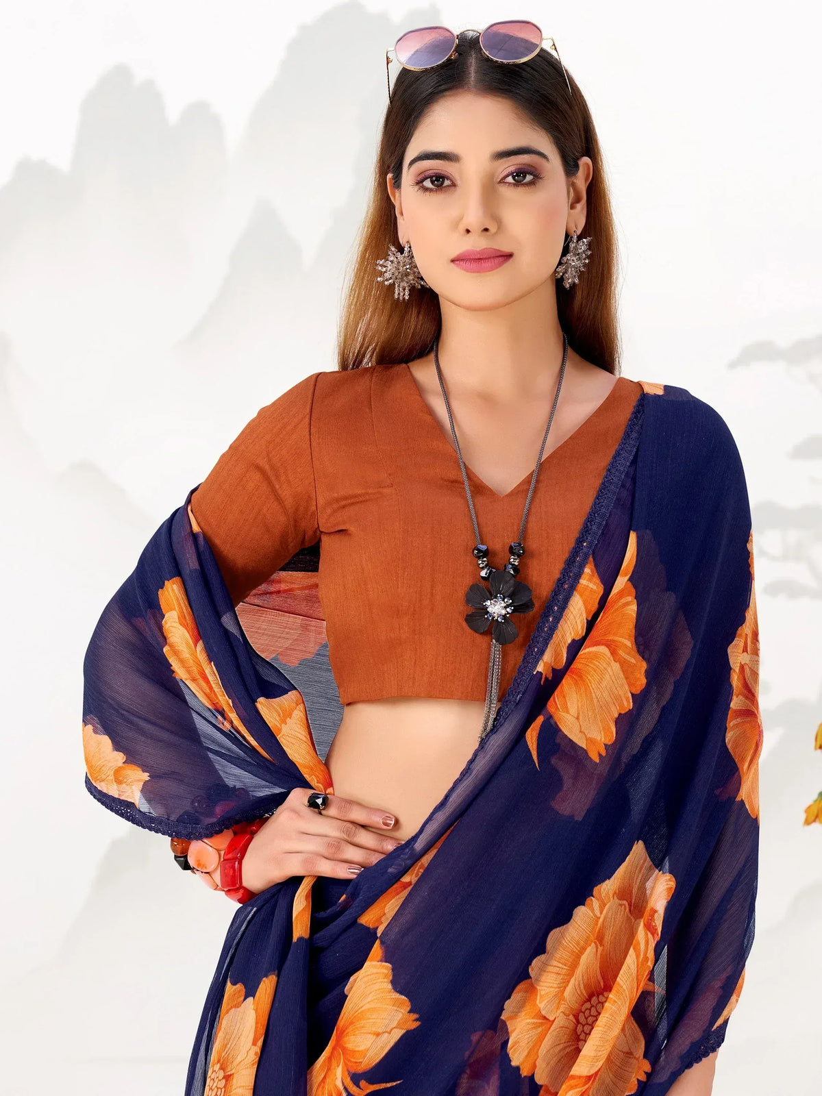 Woman in blue floral saree with orange blouse, stylish ethnic wear