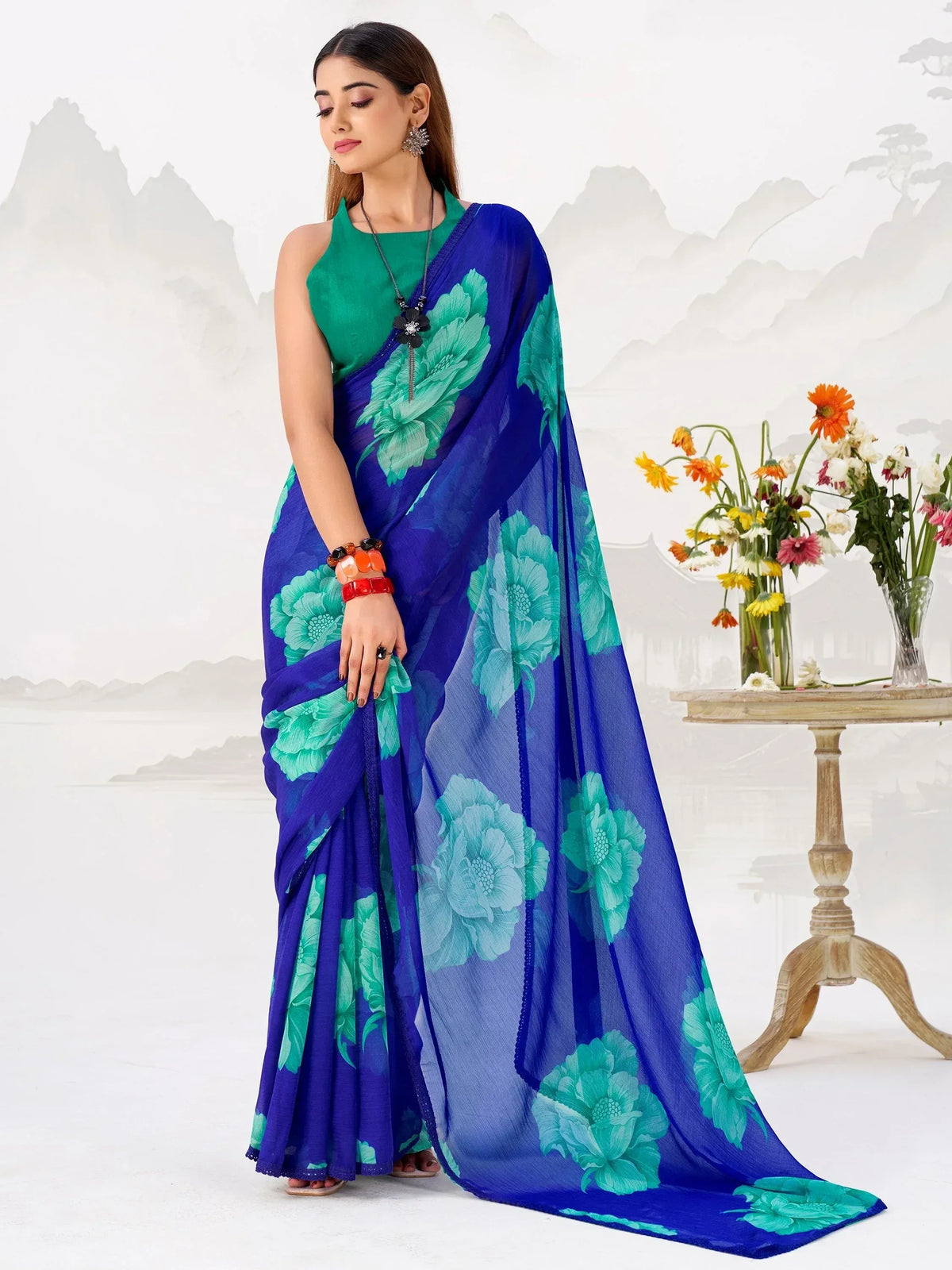 Blue saree with green floral print, paired with green blouse, elegant ethnic wear for women