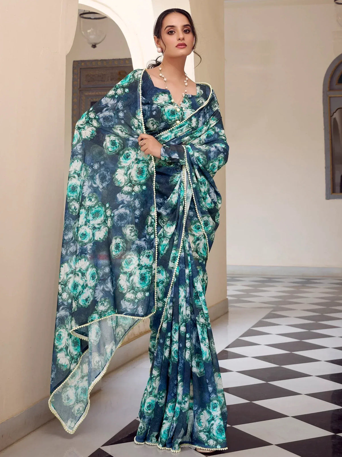 Elegant teal floral saree with pearl trim, perfect for Indian ethnic occasions
