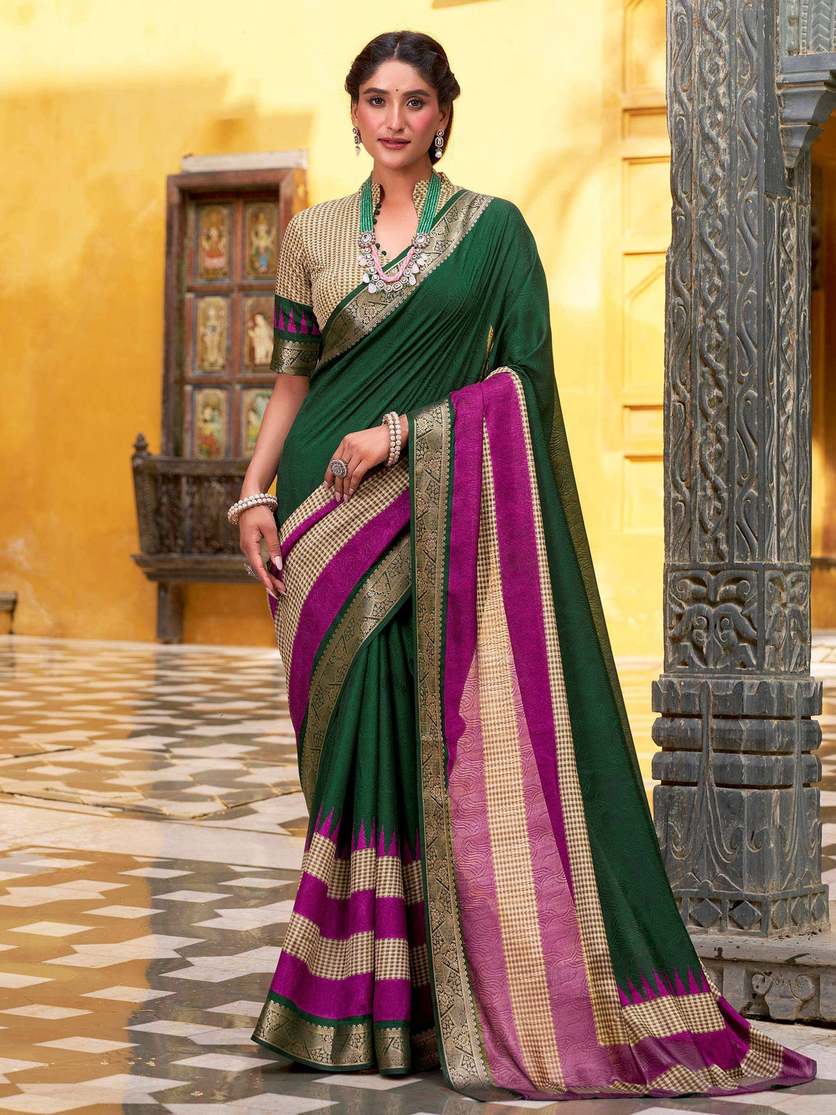 Green and magenta ethnic saree with gold border, styled with traditional jewelry for festive occasions