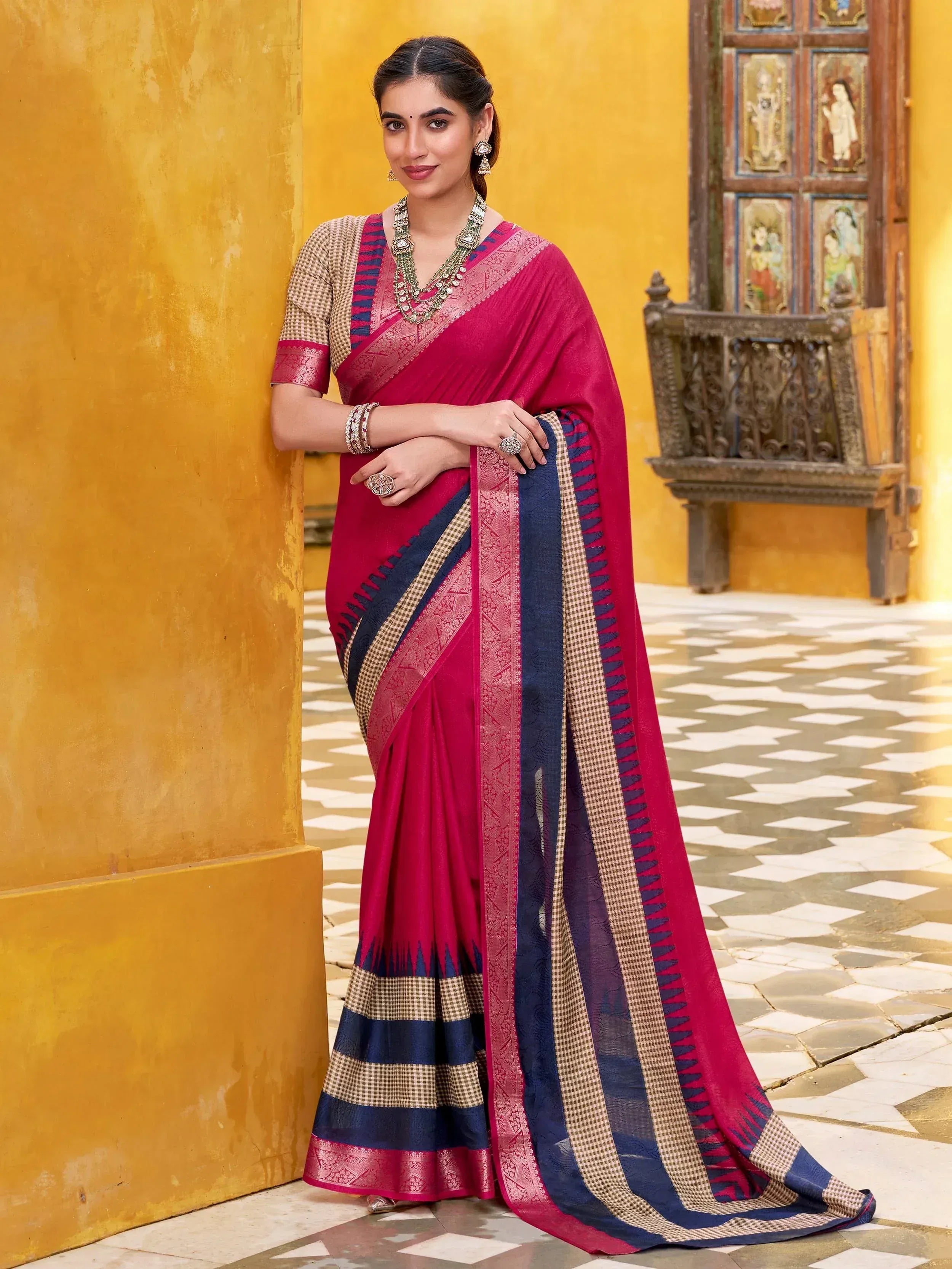 Woman in elegant maroon and navy blue ethnic saree with checkered border, perfect for Indian occasions