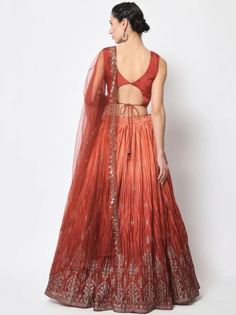 Back view of woman in maroon lehenga choli with gold embroidery and sheer dupatta, ethnic Indian wear
