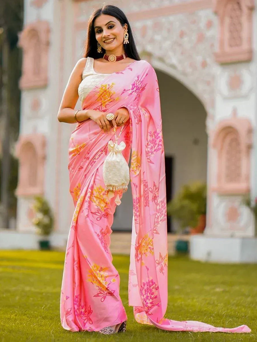 Woman in pink floral saree with white blouse, traditional Indian ethnic wear, garden setting