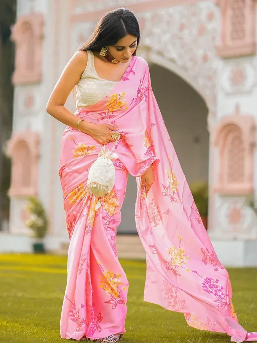 Pink floral saree with yellow accents, styled with white blouse and potli bag, perfect for ethnic occasions