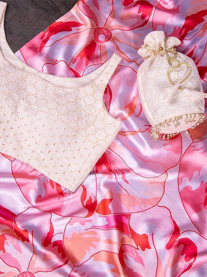 Cream embroidered blouse with pink floral saree and matching potli bag, ideal for ethnic wear occasions