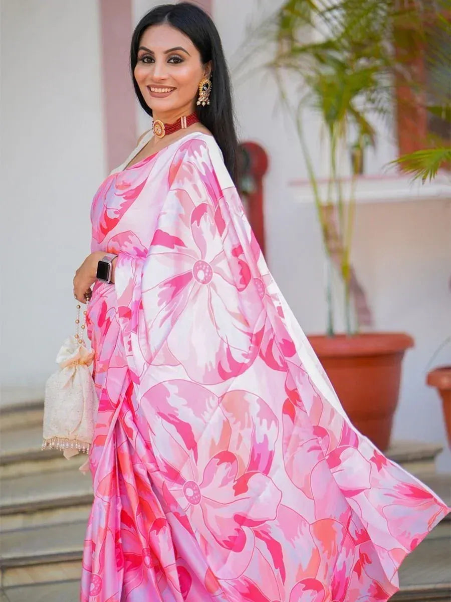 Woman in pink floral print saree with gold jewelry, perfect for ethnic occasions