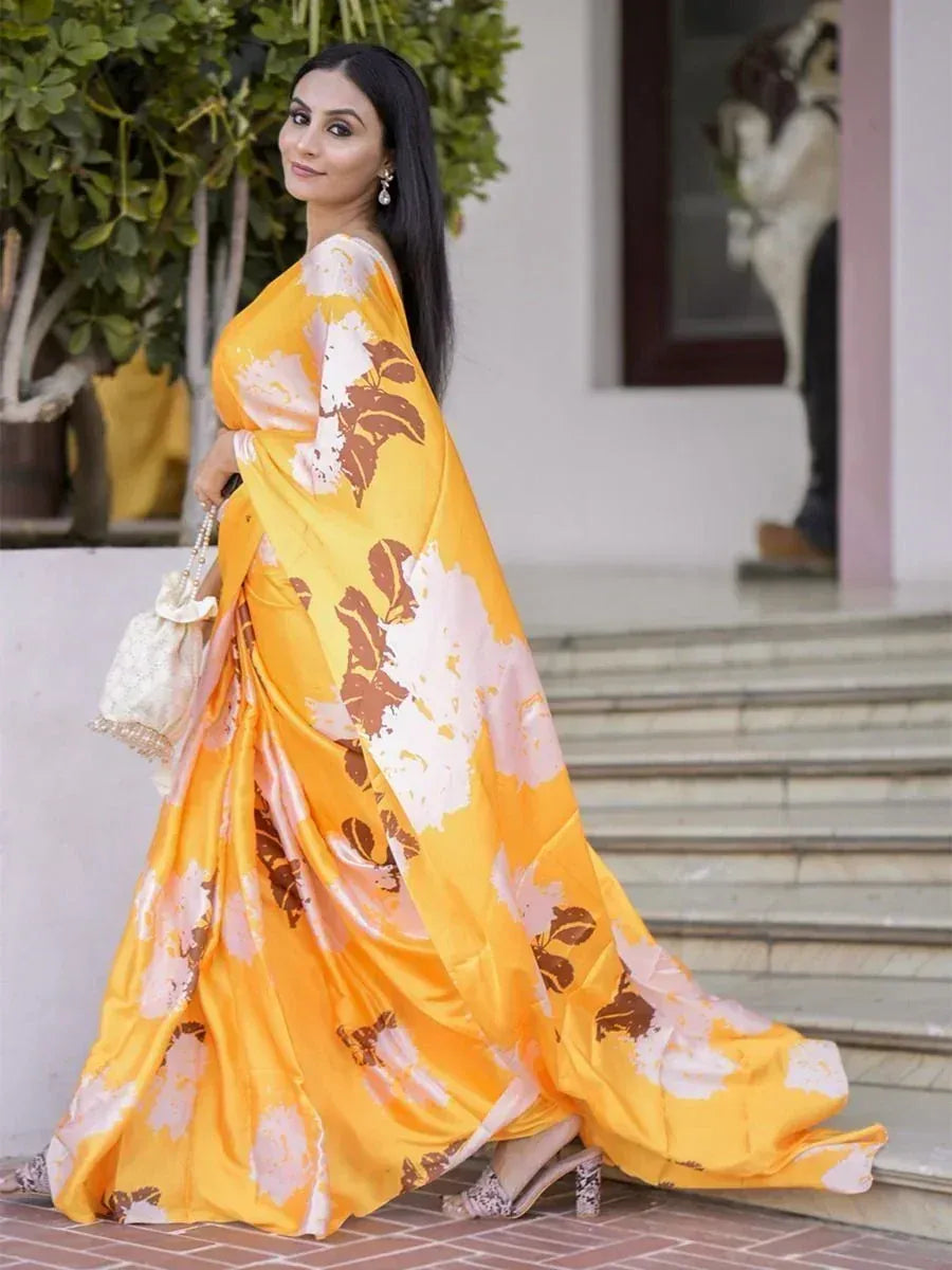 Woman in vibrant yellow floral saree with white and brown print, elegant ethnic wear for festive occasions
