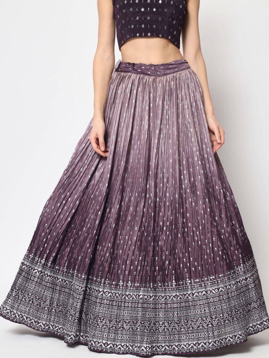 Purple pleated lehenga skirt with silver print and ethnic border, paired with matching crop top