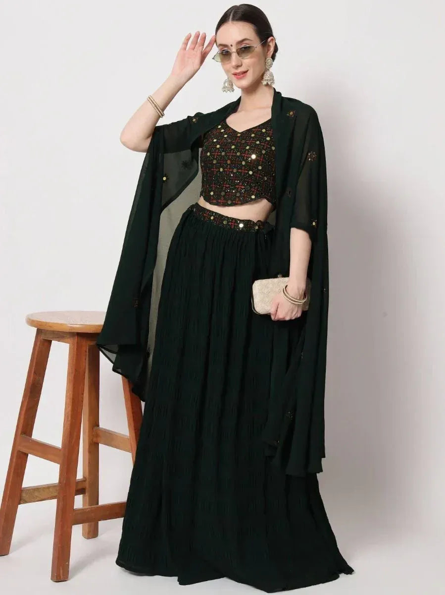 Dark green ethnic lehenga choli with sequin top and sheer cape, perfect for festive occasions