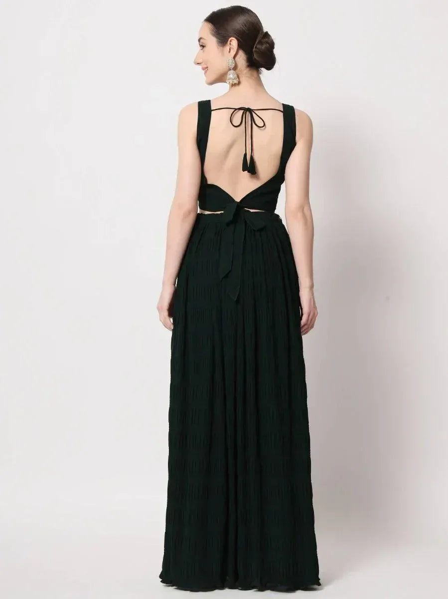 Elegant dark green ethnic gown with open back, tie-up detail, and pleated skirt for women