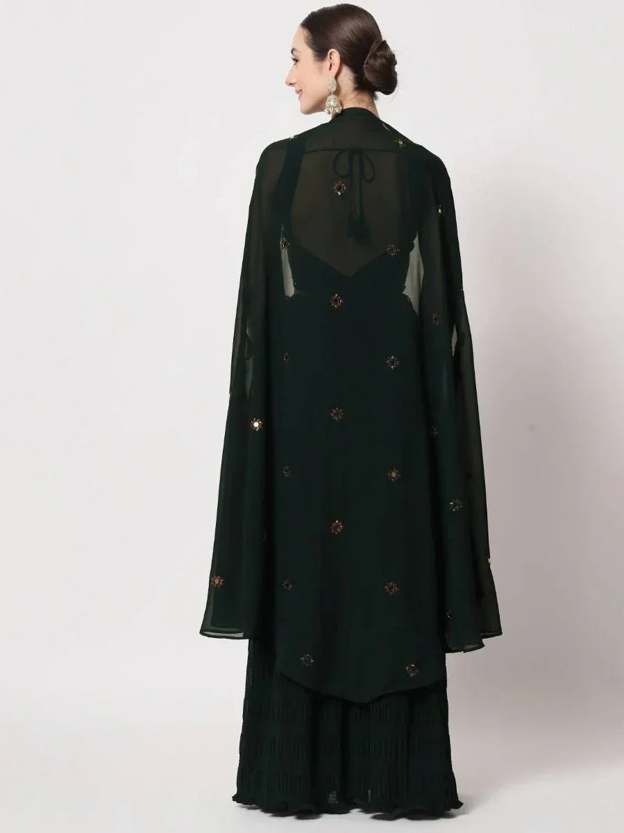 Emerald green ethnic gown with sheer cape and floral embroidery, perfect for Indian occasions.