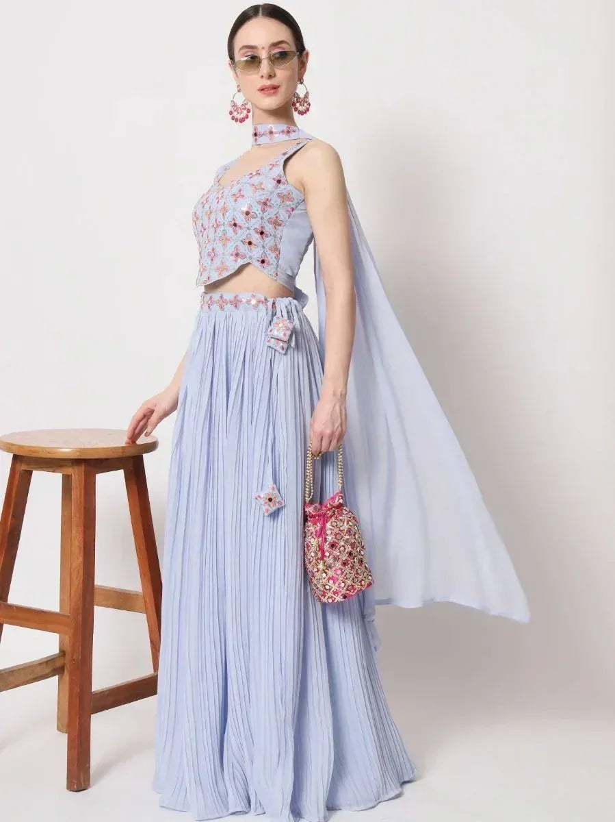 Light blue embroidered lehenga choli with pleated skirt, cape, and matching potli bag for Indian ethnic wear