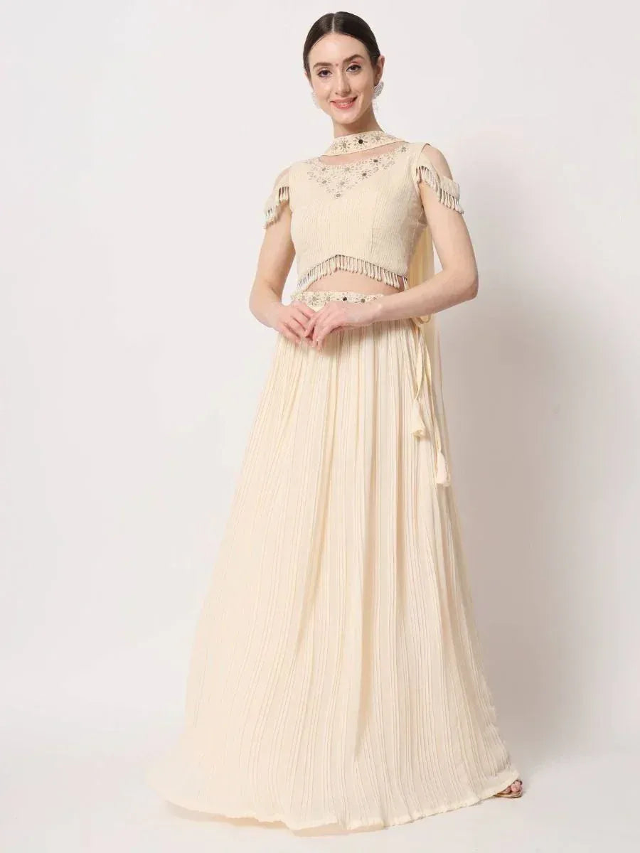 Cream embroidered lehenga choli with fringe detailing, perfect for Indian ethnic occasions