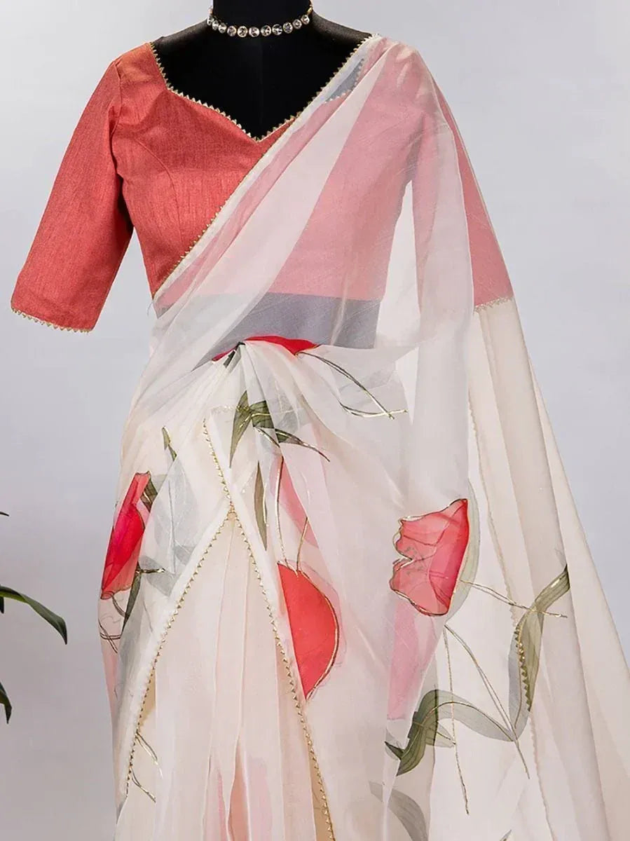 White saree with pink floral print, paired with coral blouse, ethnic wear for women