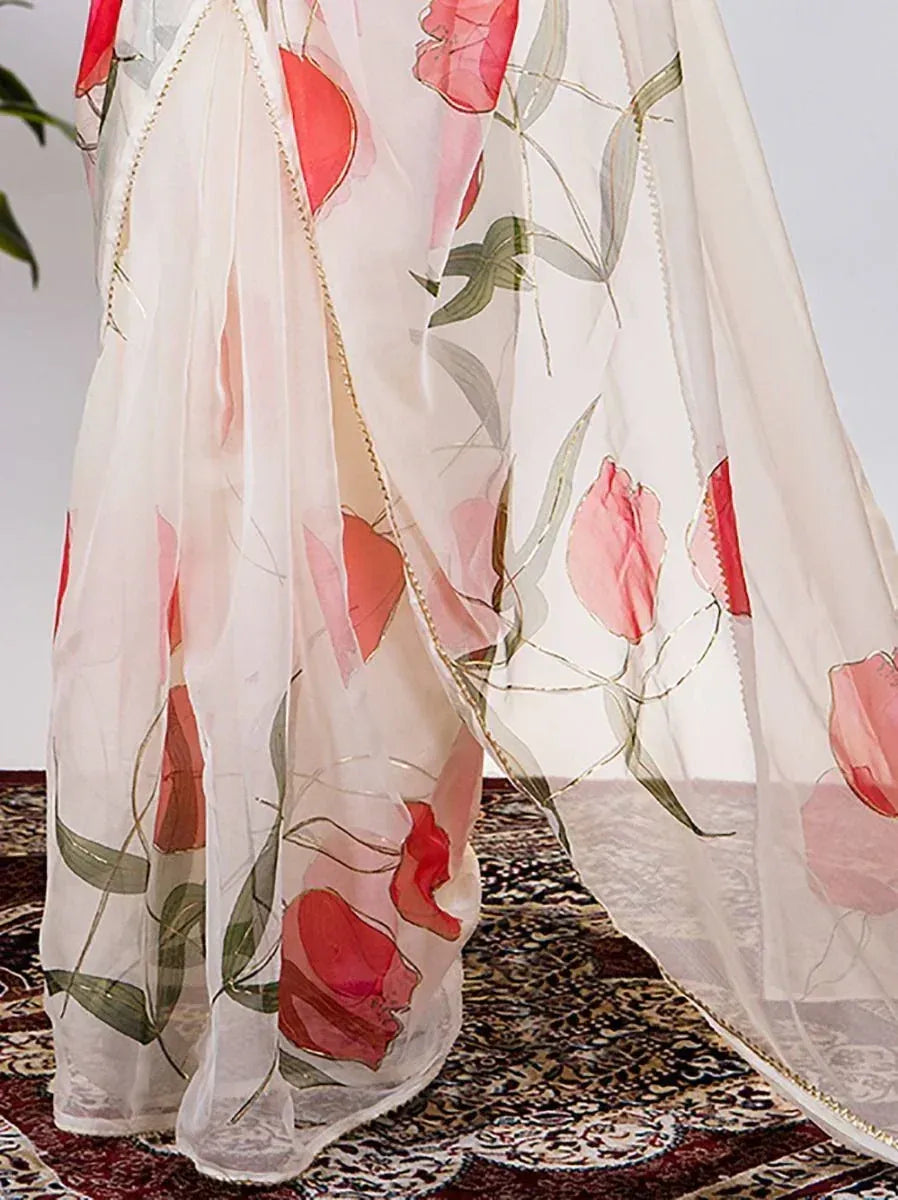 White floral print saree with pink tulips and gold trim, elegant Indian ethnic wear
