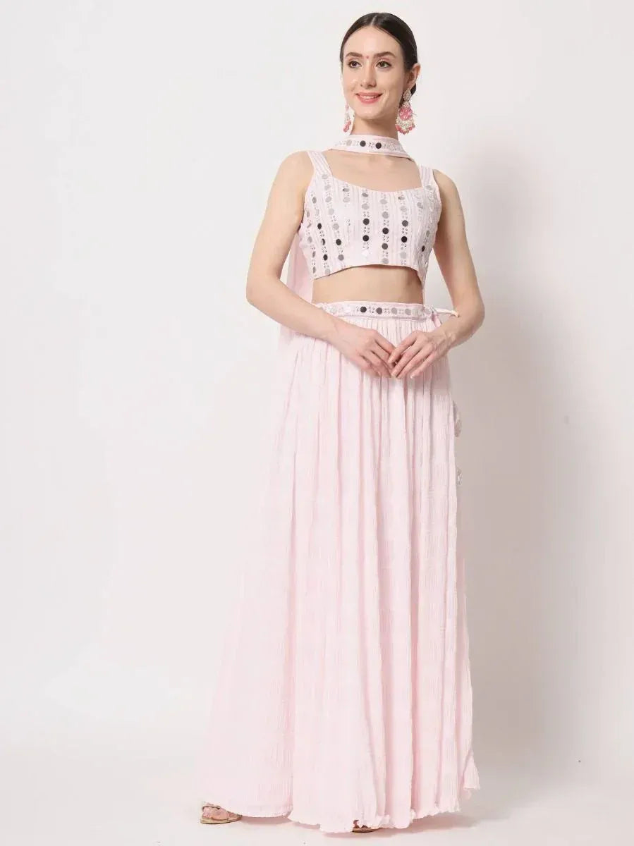 Pink ethnic lehenga choli with mirror work top and pleated skirt, perfect for Indian occasions