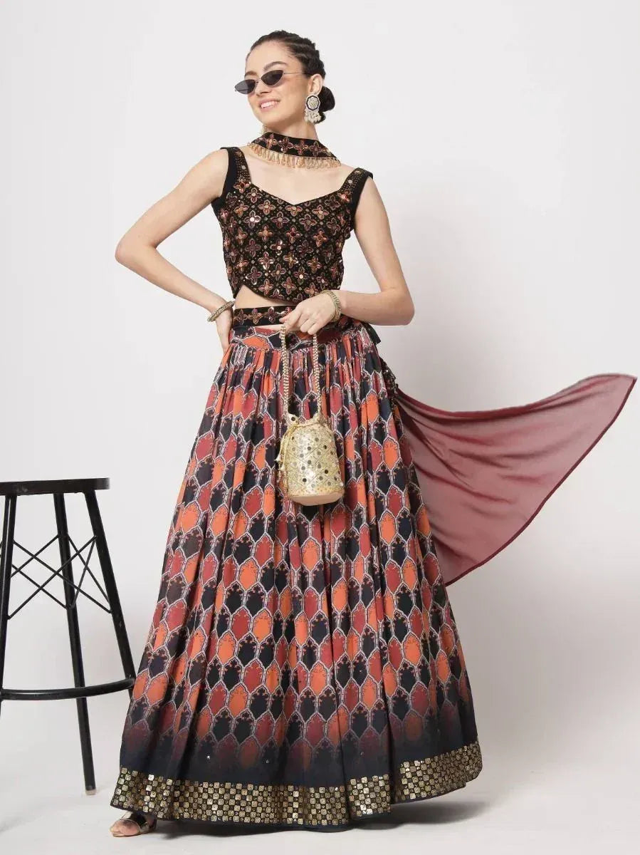 Stylish black and orange printed lehenga choli with gold embroidery, perfect for Indian ethnic occasions