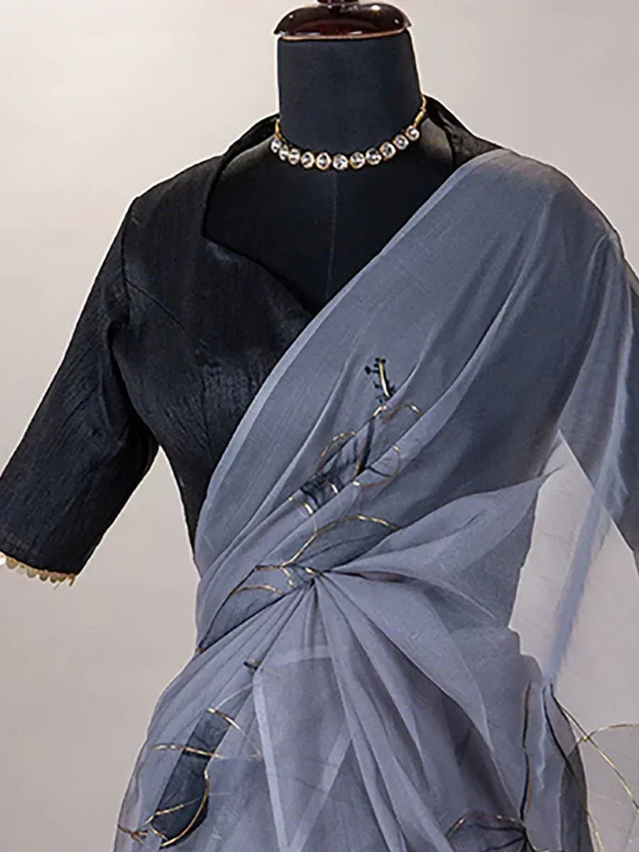 Grey saree with gold embroidery and black blouse, styled on mannequin for ethnic wear