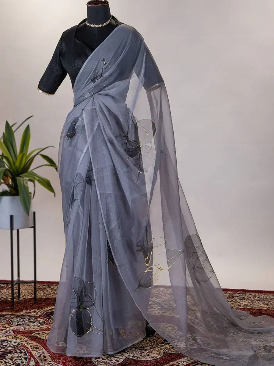 Grey sheer saree with floral embroidery, paired with black blouse, elegant Indian ethnic wear