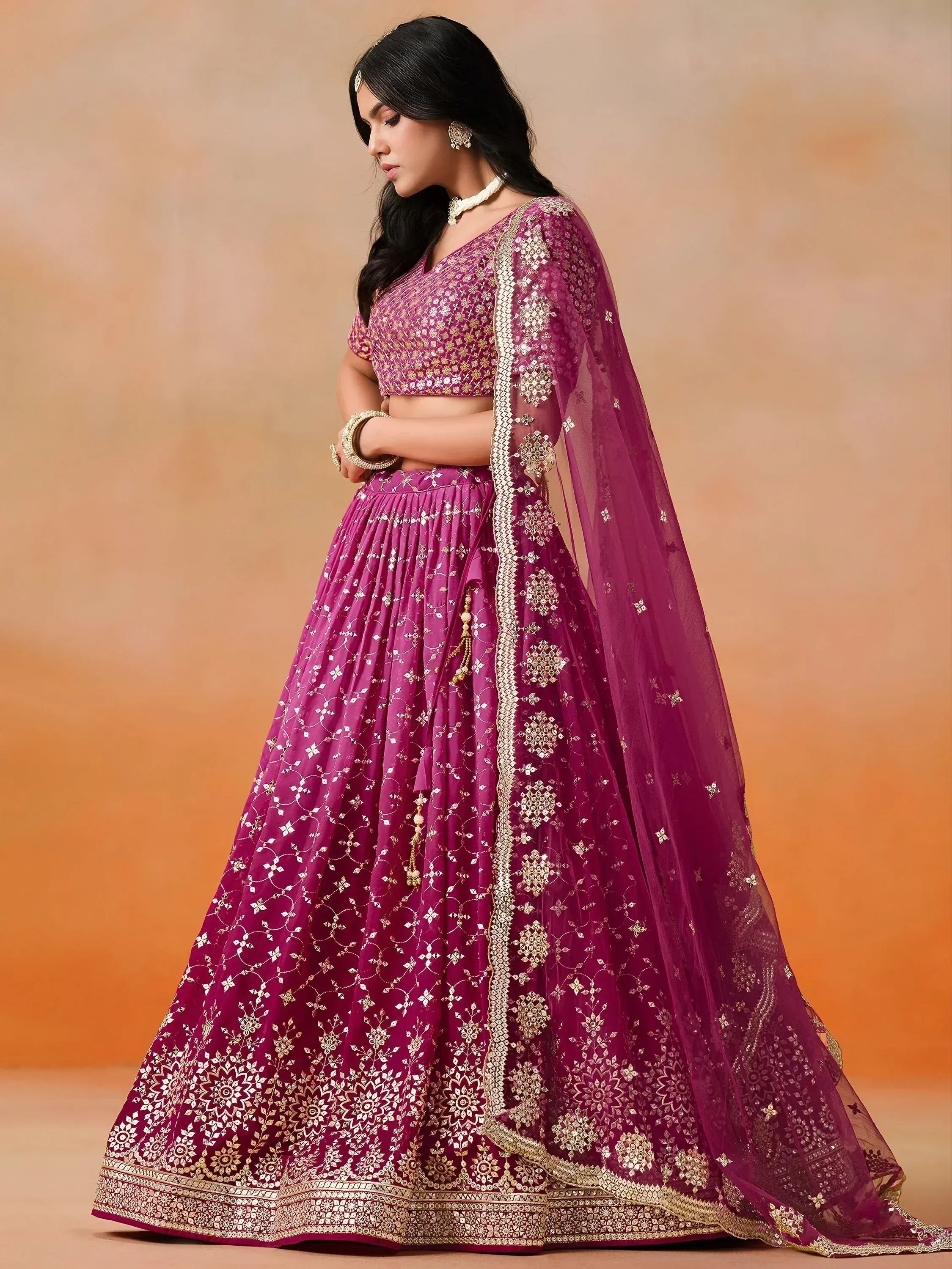 Purple designer lehenga choli with gold embroidery and sheer dupatta, perfect for Indian weddings and festive occasions