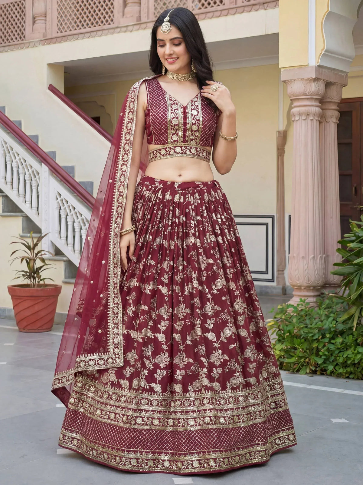 Maroon lehenga choli with gold embroidery, perfect for Indian ethnic wear and festive occasions.
