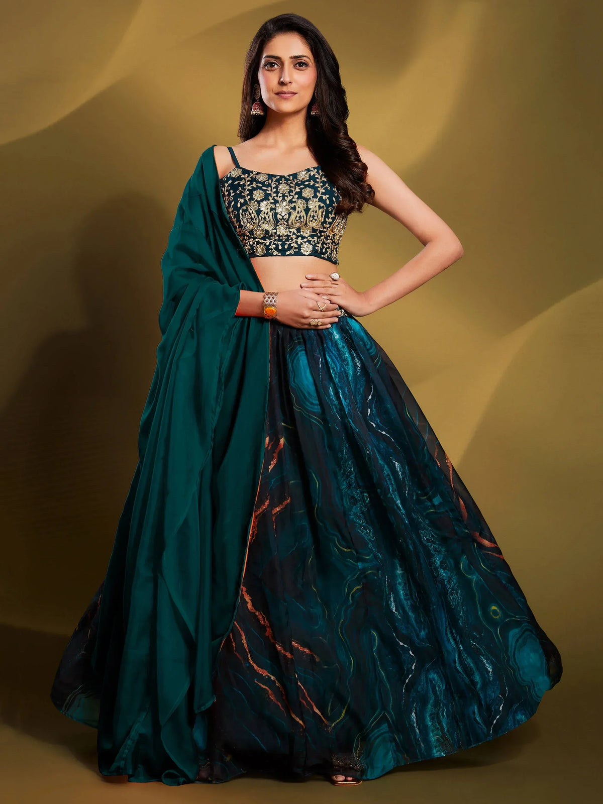 Elegant teal lehenga choli with gold embroidery and marble print skirt, perfect for Indian ethnic wear occasions