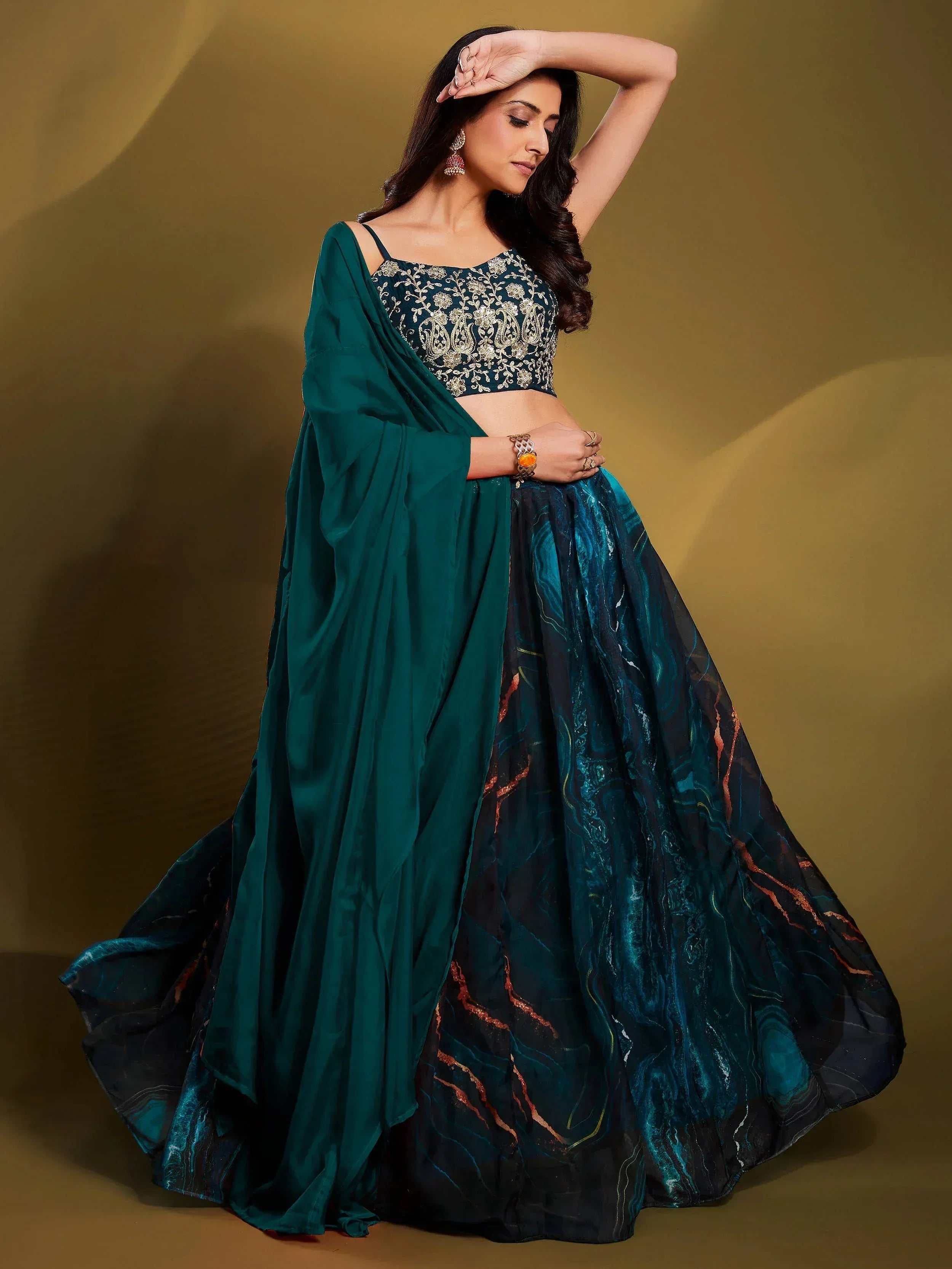 Emerald green lehenga choli with gold embroidery and marble print skirt, perfect for Indian ethnic wear events.