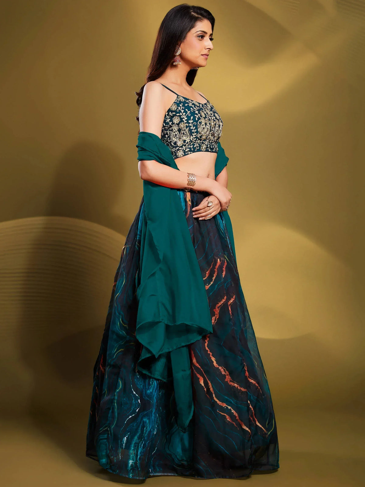 Emerald green embroidered lehenga choli with marble print skirt, perfect for Indian ethnic wear events.
