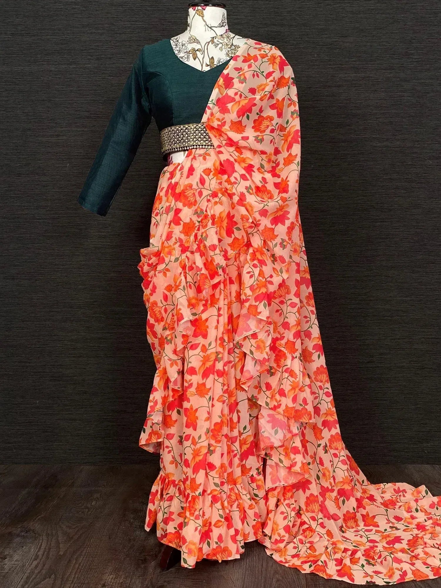 Floral printed saree with ruffled layers and dark green blouse, ethnic Indian wear