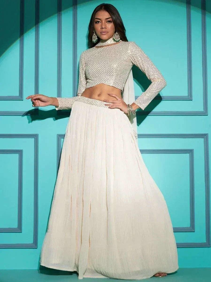 Elegant off-white lehenga choli with sequin top and pleated skirt, perfect for Indian ethnic wear occasions