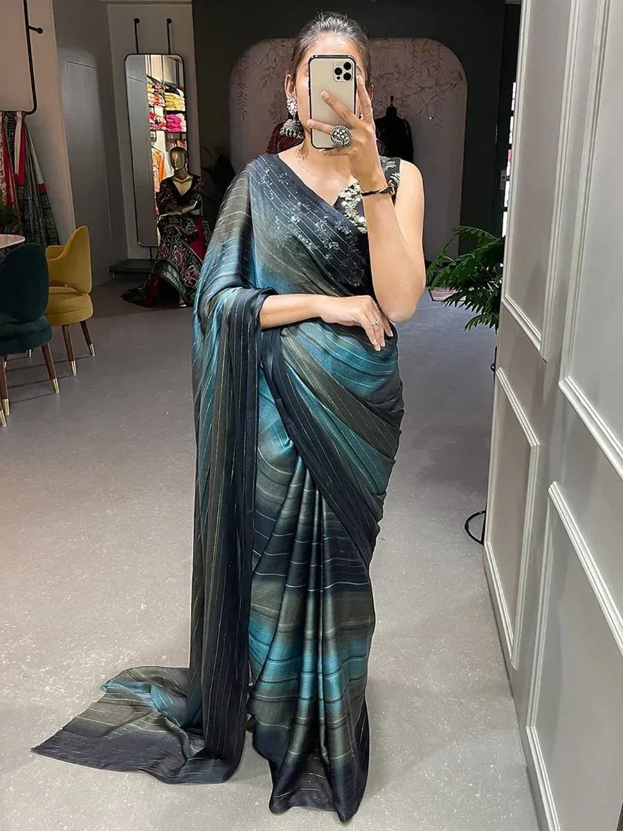 Woman in elegant teal and black striped saree with designer blouse, perfect for Indian ethnic wear occasions