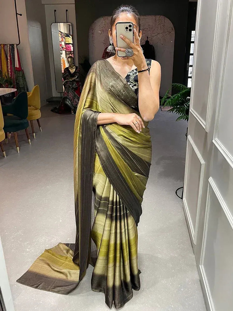 Woman wearing olive green and black striped saree with designer blouse, perfect for ethnic occasions.