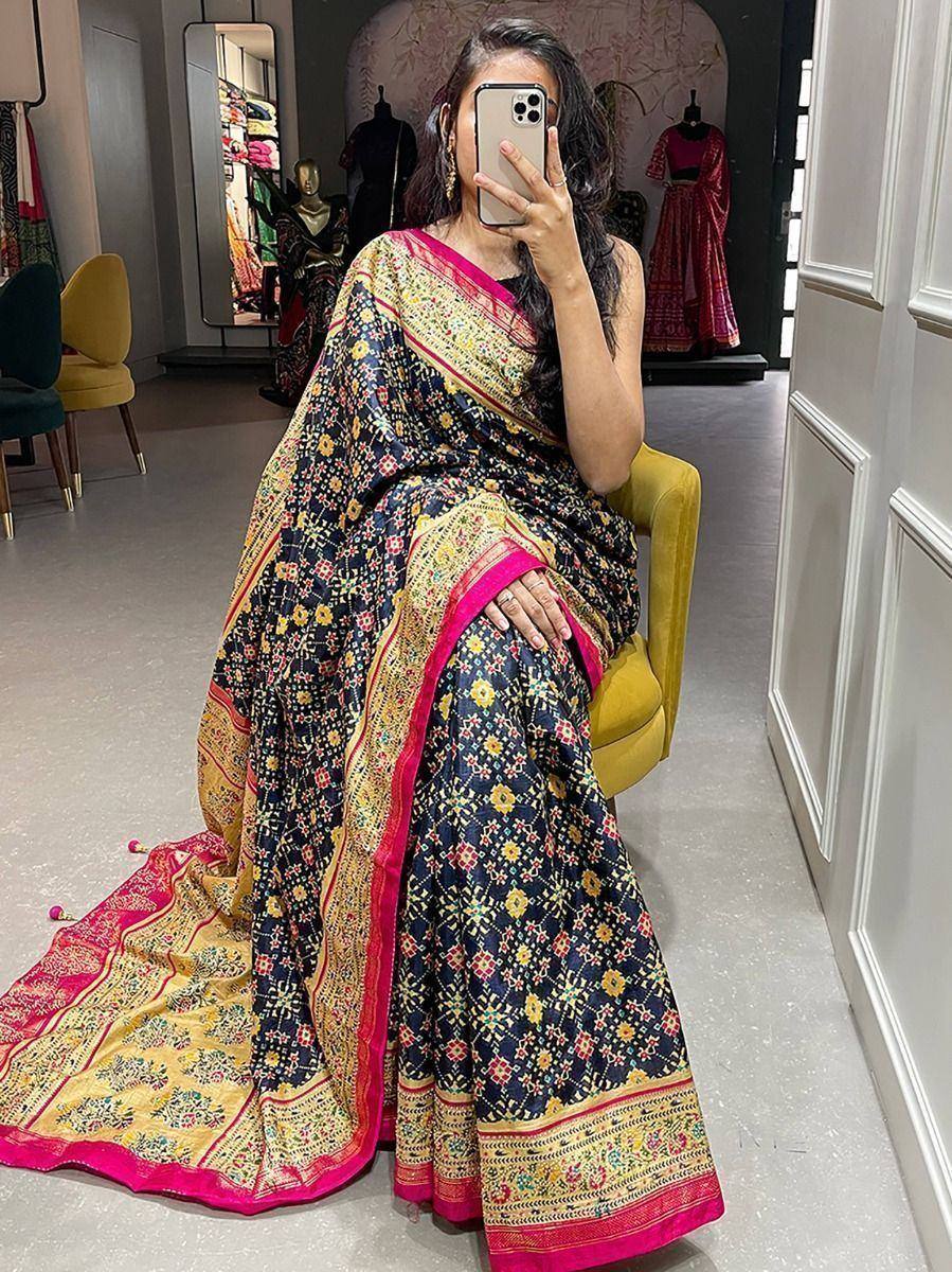 Elegant black floral saree with pink and gold border, perfect for Indian ethnic wear