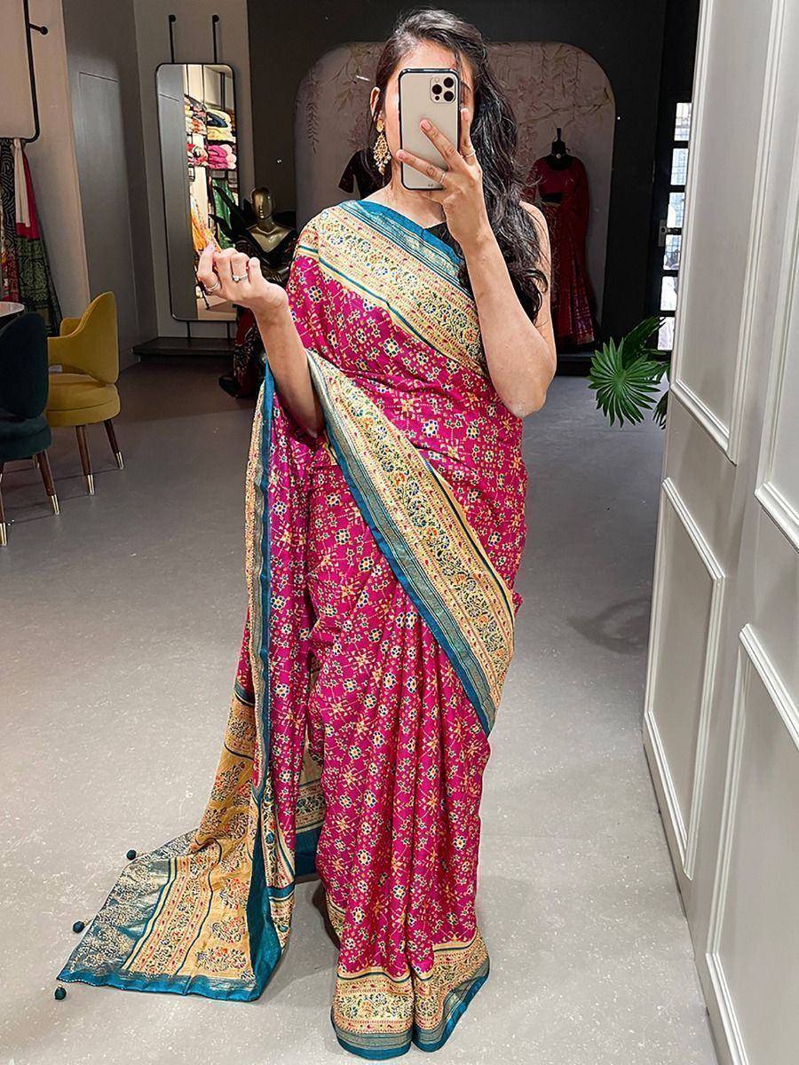 Vibrant pink floral saree with blue and gold border, styled for ethnic wear