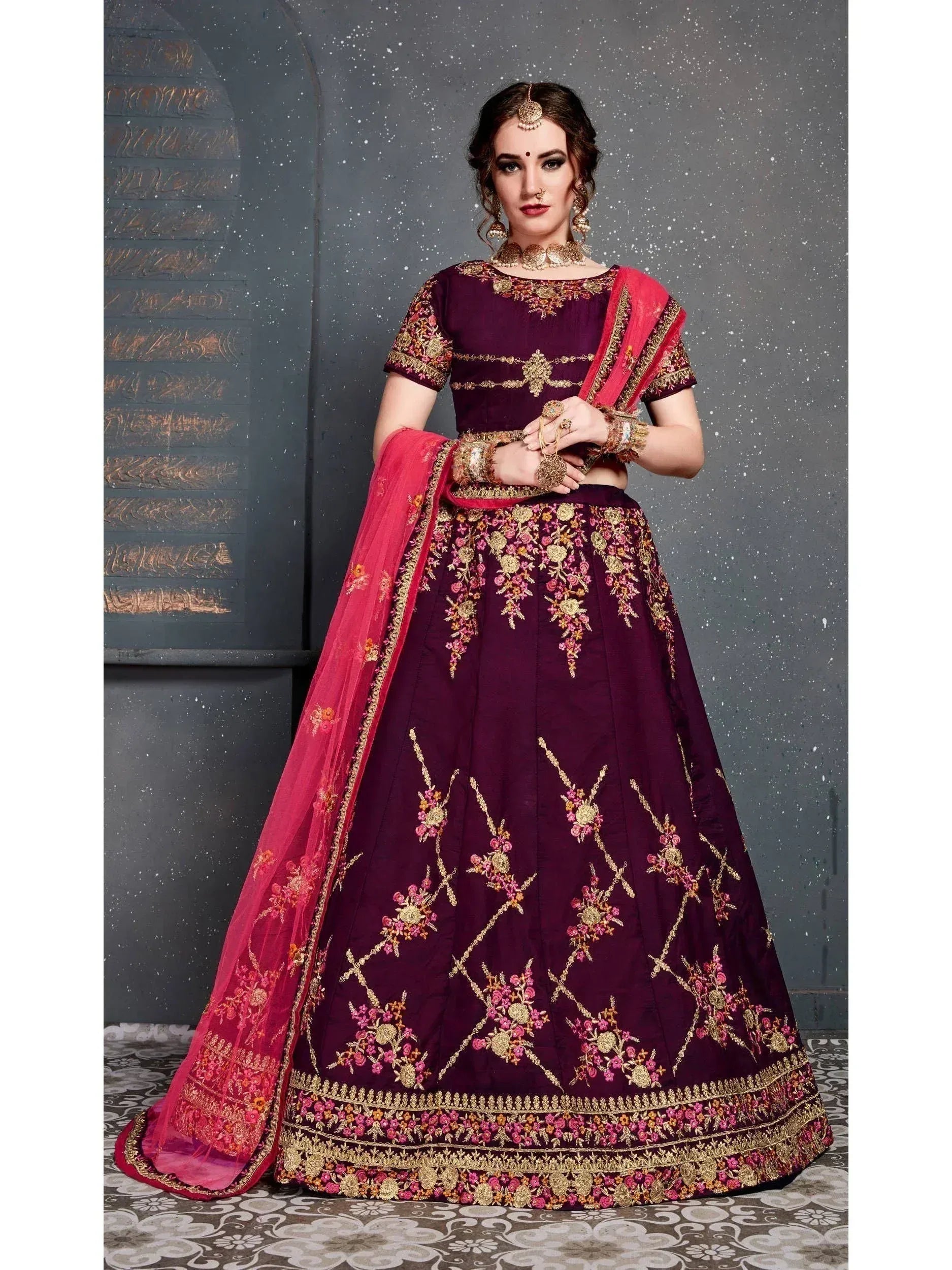 Elegant maroon lehenga choli with gold floral embroidery and pink dupatta, perfect for Indian weddings and festive occasions.