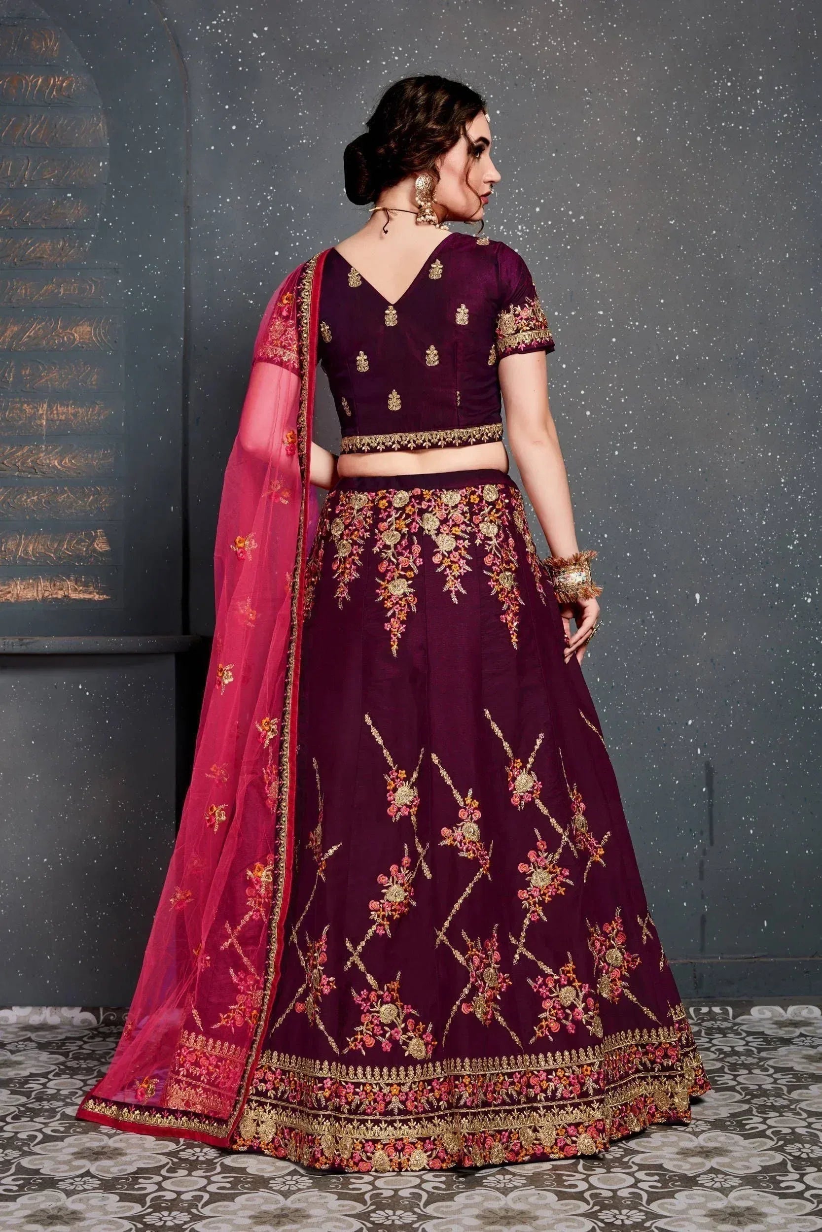 Elegant maroon lehenga choli with gold floral embroidery and pink dupatta, perfect for Indian weddings and festive occasions.