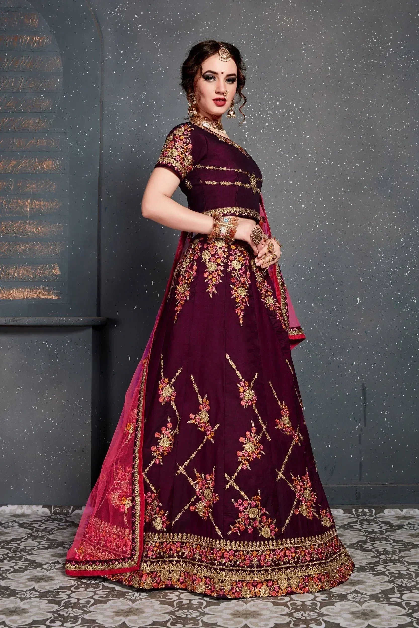 Elegant maroon lehenga choli with gold floral embroidery, perfect for Indian weddings and festive occasions.