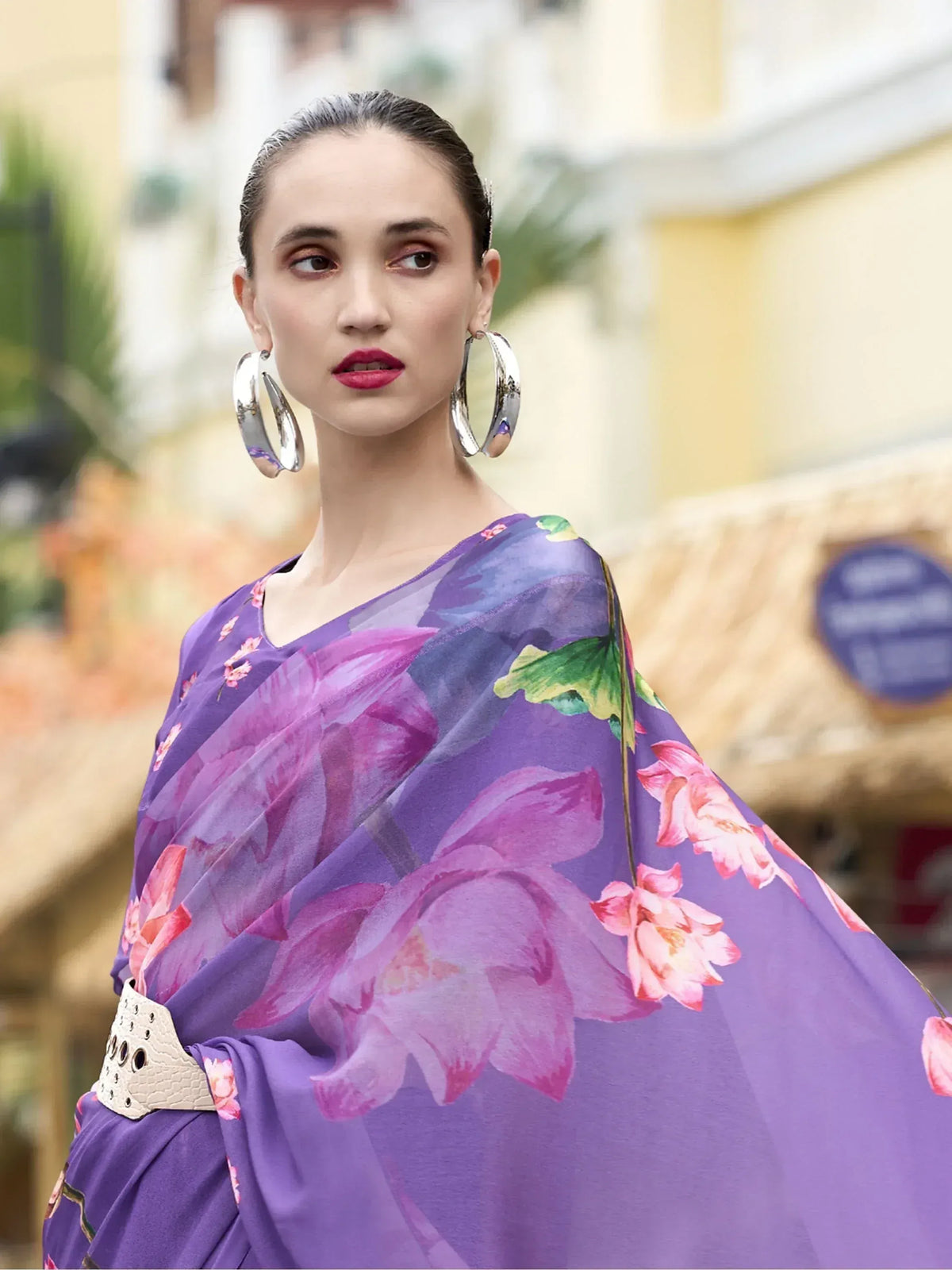 Purple floral print ethnic gown with belt, styled with hoop earrings for modern Indian fashion