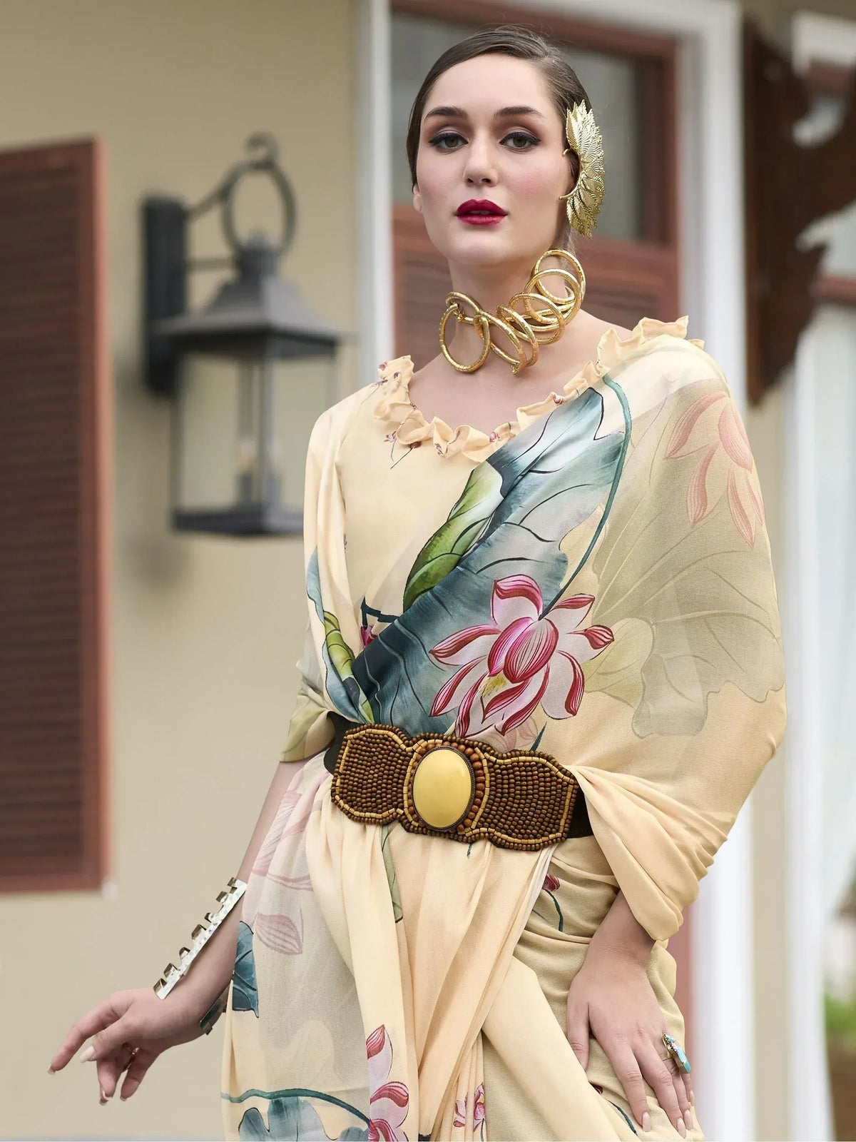 Woman in floral printed ethnic gown with gold jewelry, perfect for Indian occasions