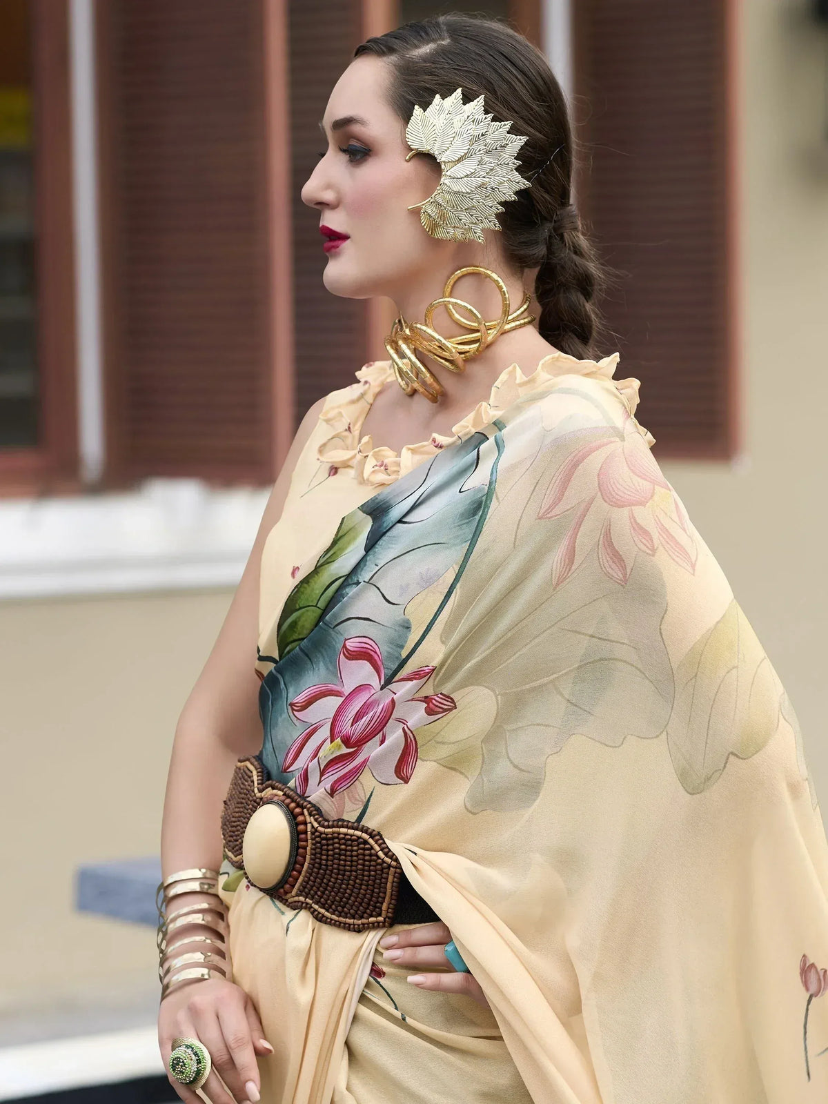Woman in floral printed saree with gold leaf hair accessory and statement jewelry