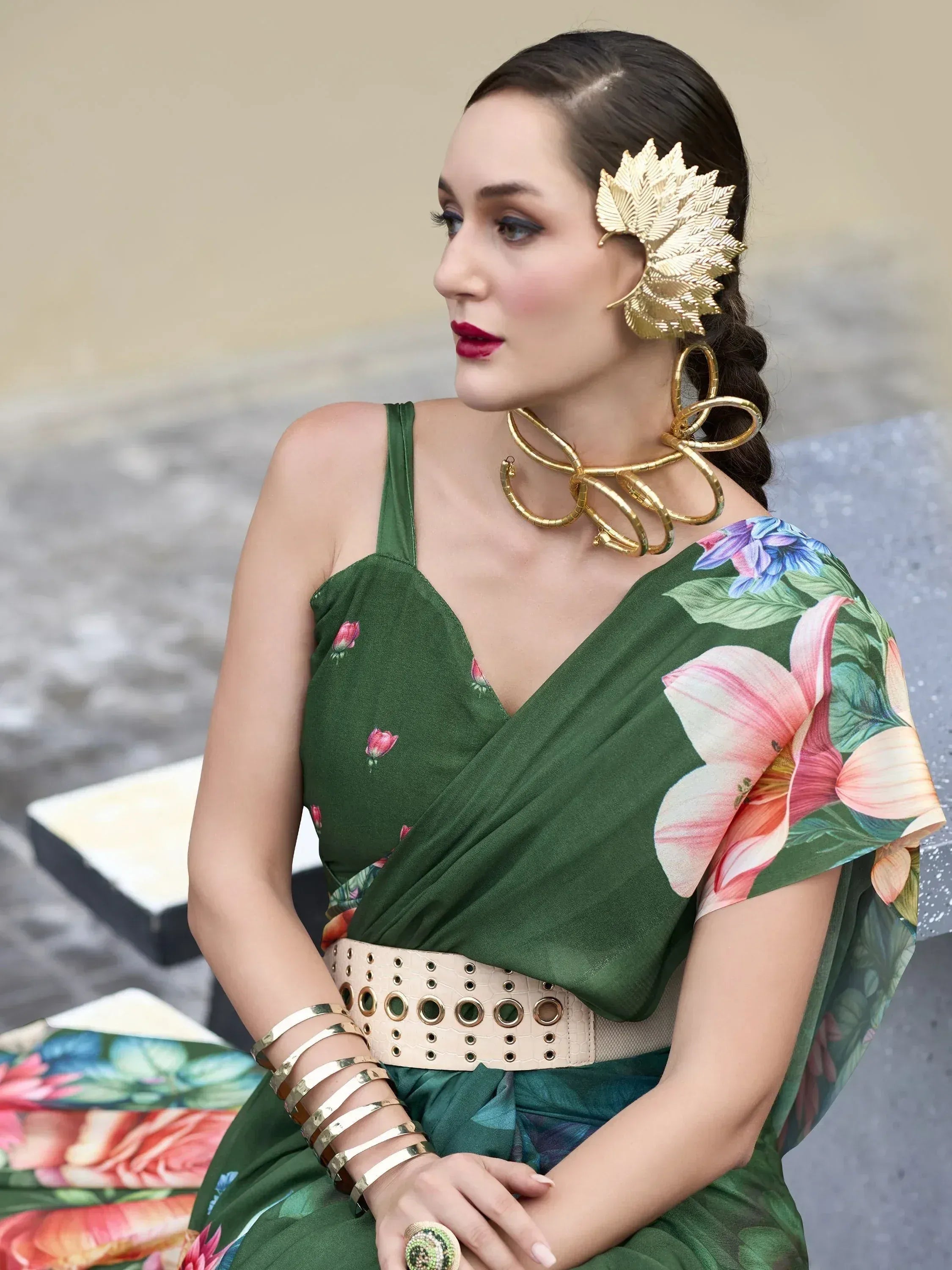 Green floral saree with gold leaf hair accessory and statement jewelry, ethnic wear style