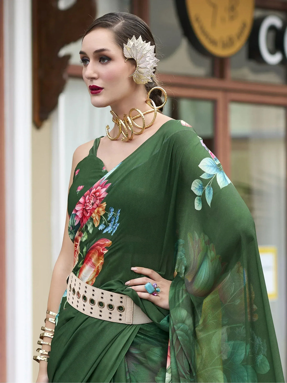 Green floral print saree with gold jewelry, perfect for ethnic occasions and Indian wear.