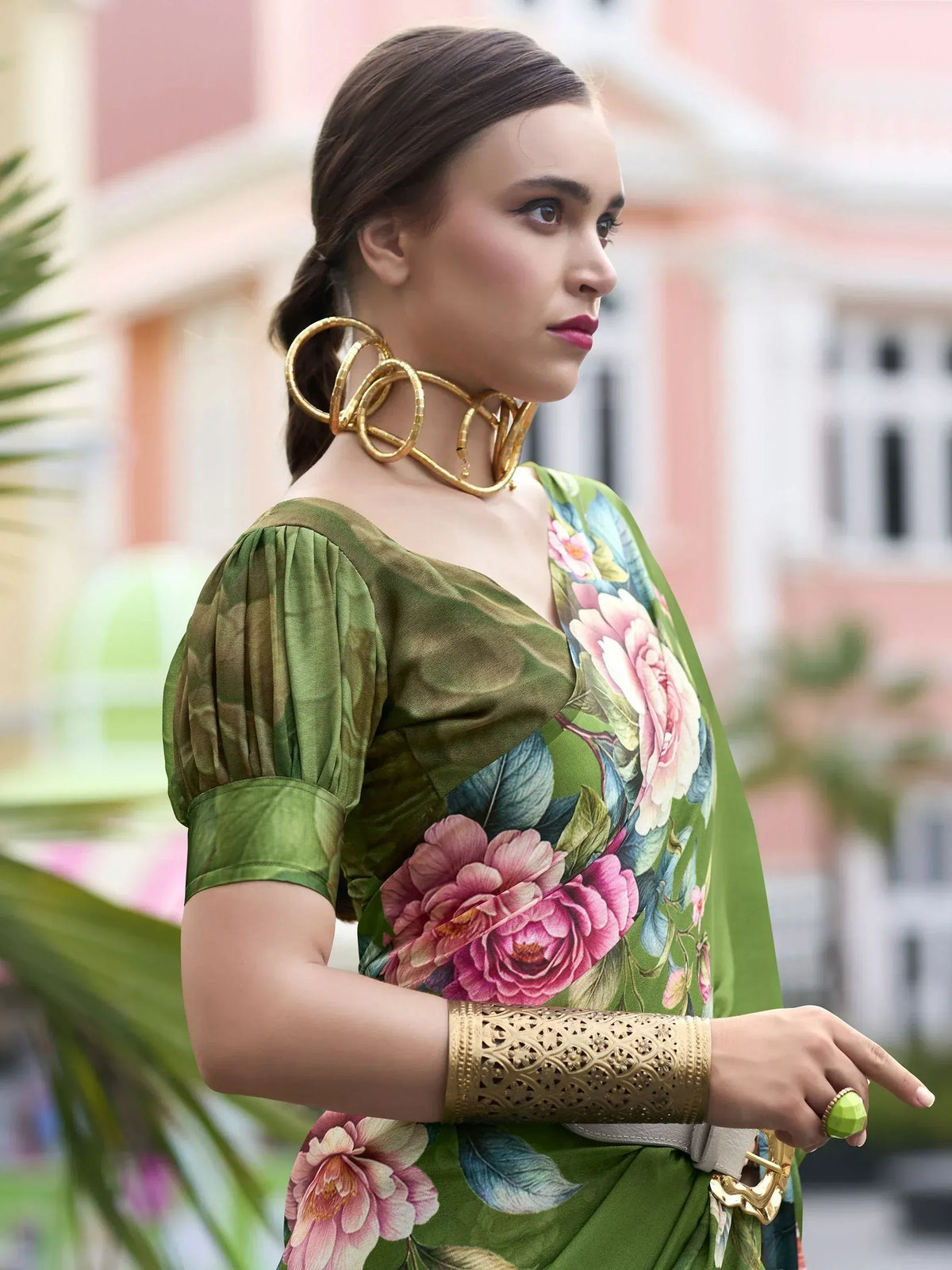 Woman in green floral saree with gold jewelry, stylish ethnic wear for women