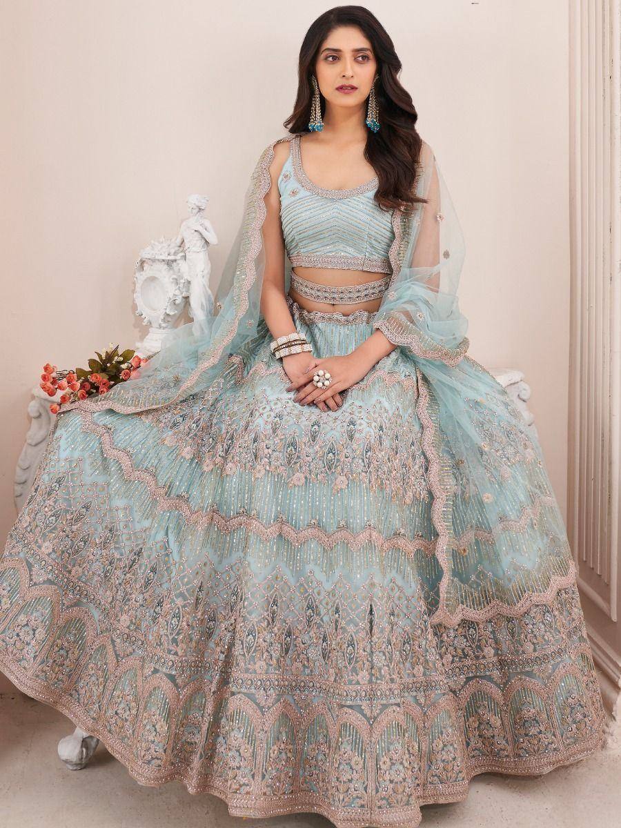Light blue designer lehenga choli with intricate embroidery and matching dupatta, perfect for weddings and festive occasions.