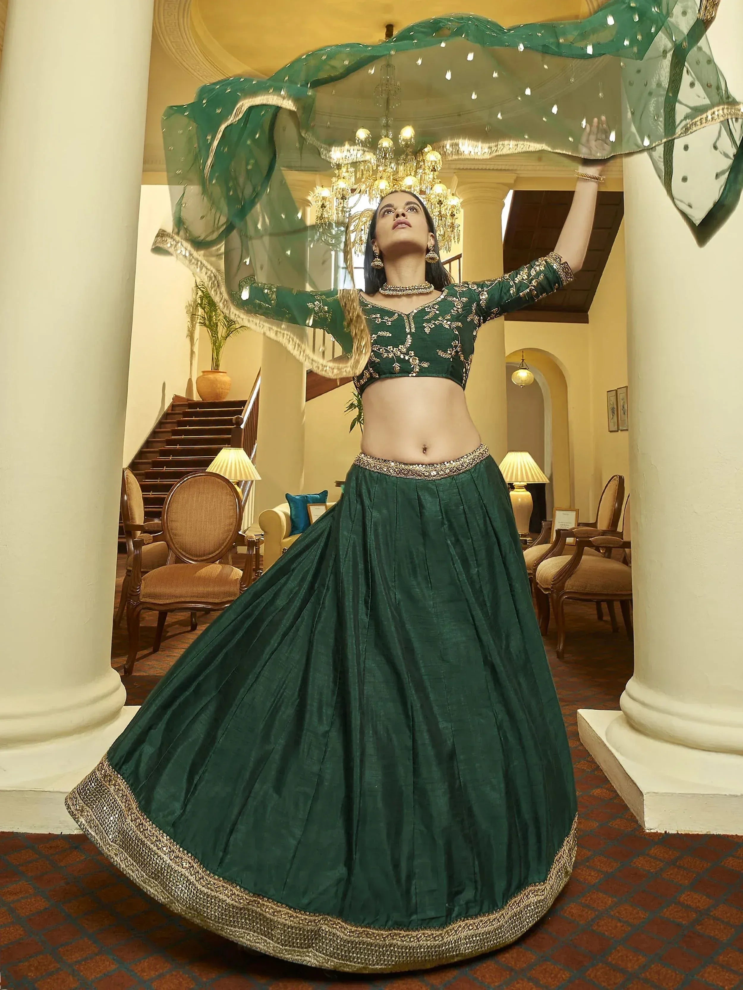 Emerald green designer lehenga choli with gold embroidery, perfect for Indian weddings and festive occasions.